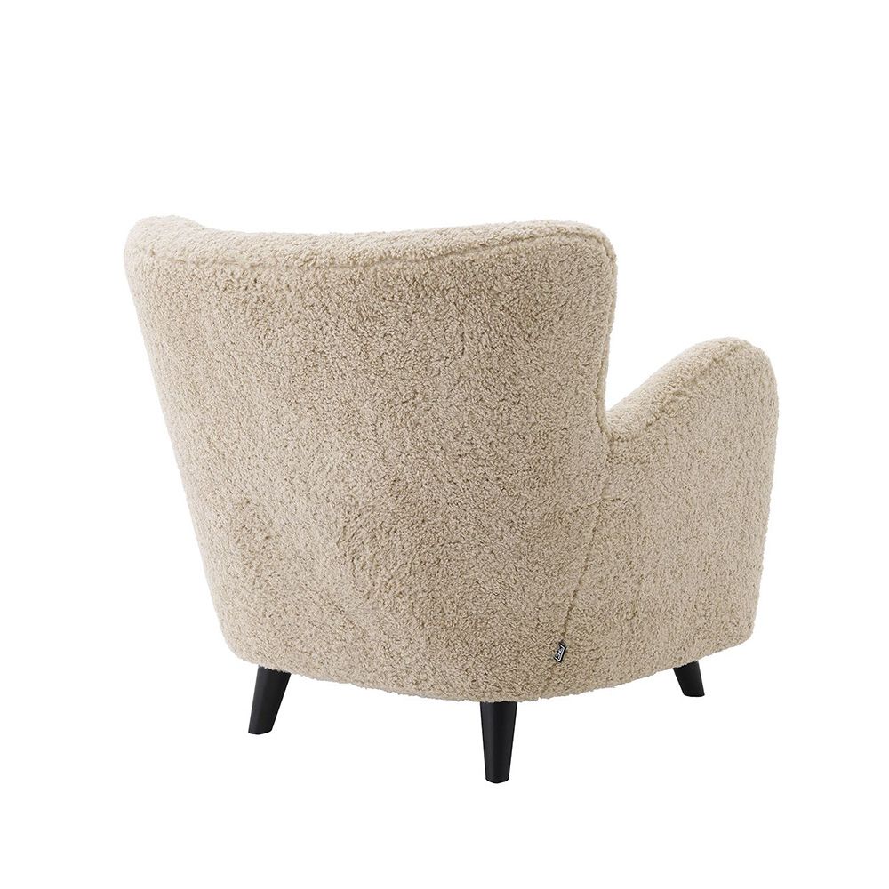 A luxurious fluffy cream-coloured mid-century inspired armchair