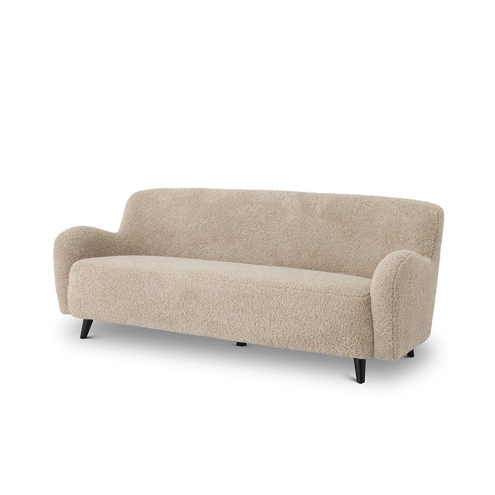 A luxurious mid-century modern inspired Canberra sand upholstered sofa with black legs