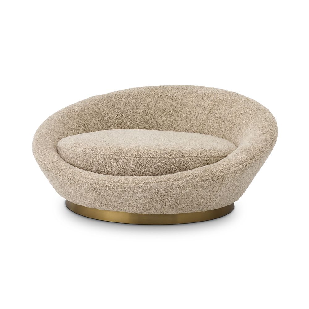 A sumptuous sofa by Eichholtz with a brushed brass base