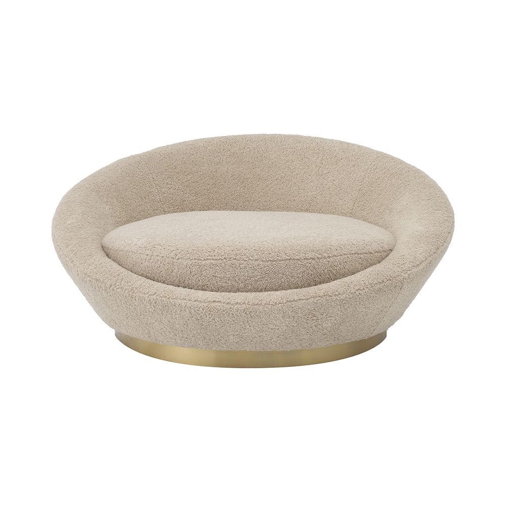 A sumptuous sofa by Eichholtz with a brushed brass base