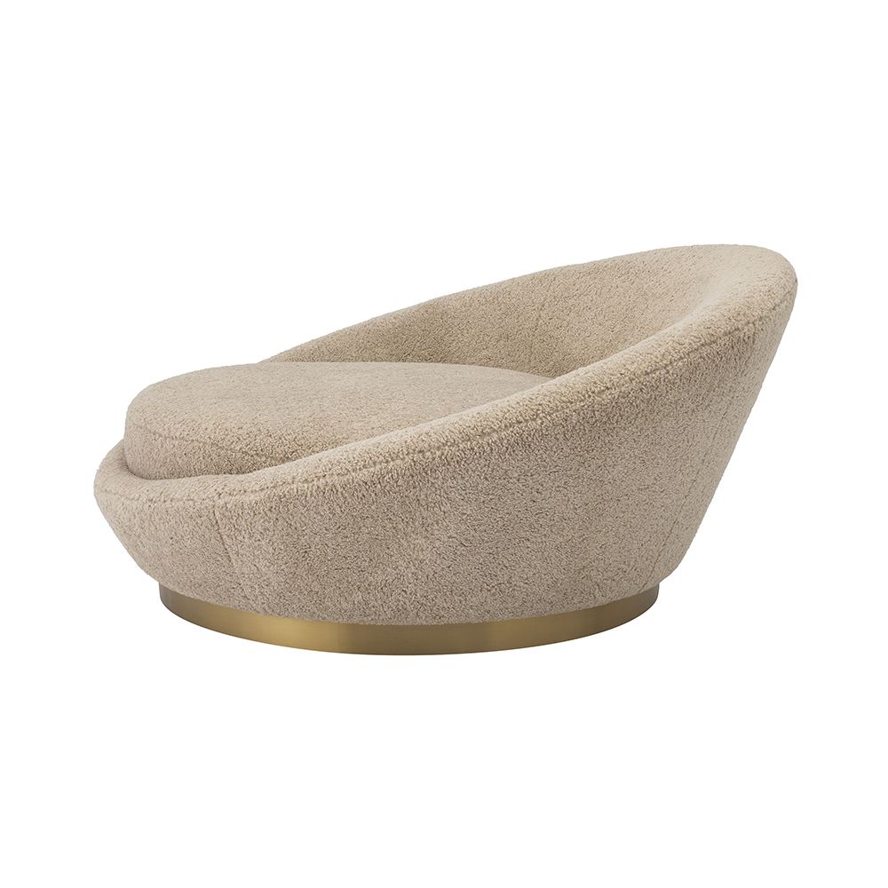 A sumptuous sofa by Eichholtz with a brushed brass base