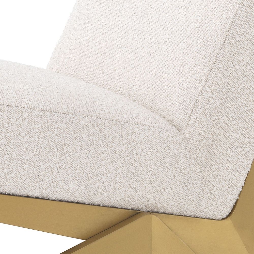 Modern Eichholtz boucle cream chair with brushed brass accents