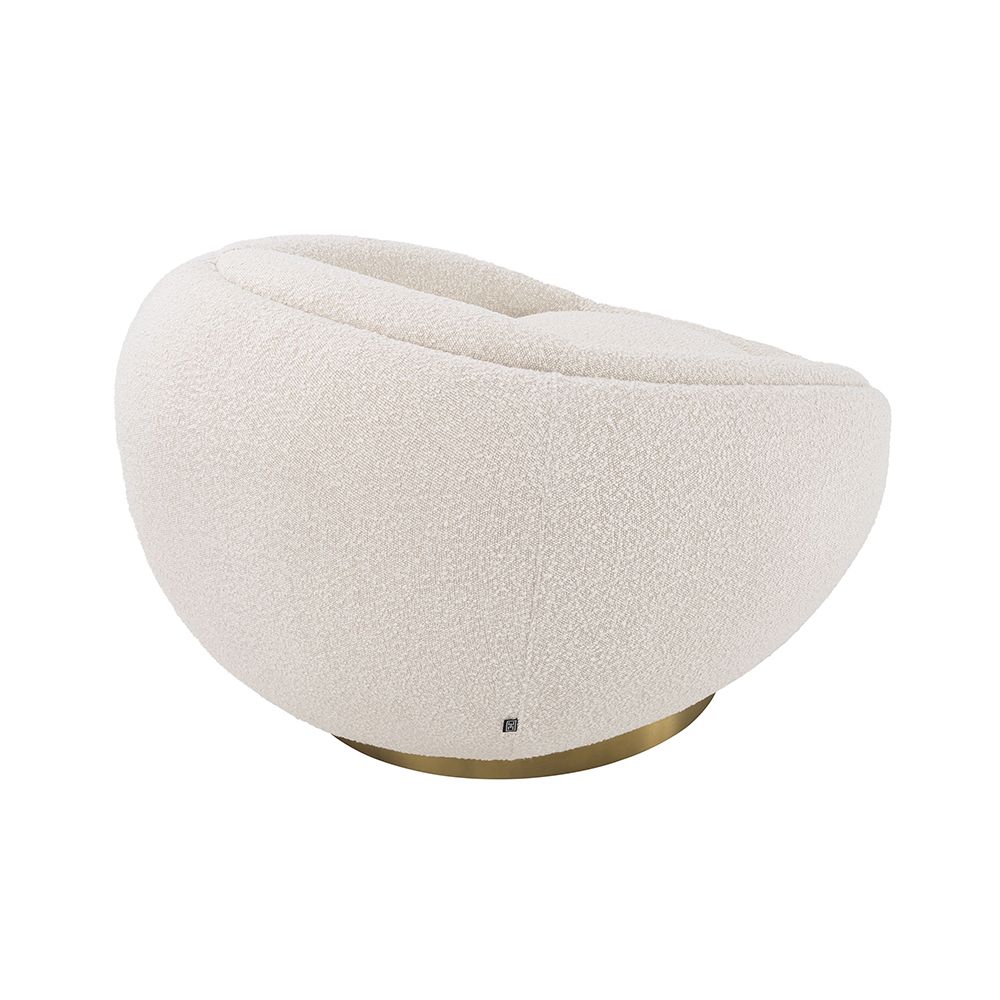 A sumptuous swivel chair by Eichholtz with a chic circular design, beautiful boucle cream upholstery and glamorous brushed brass base
