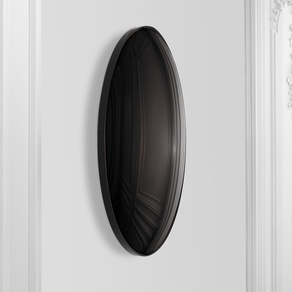 A luxurious round wall mirror with a black convex surface