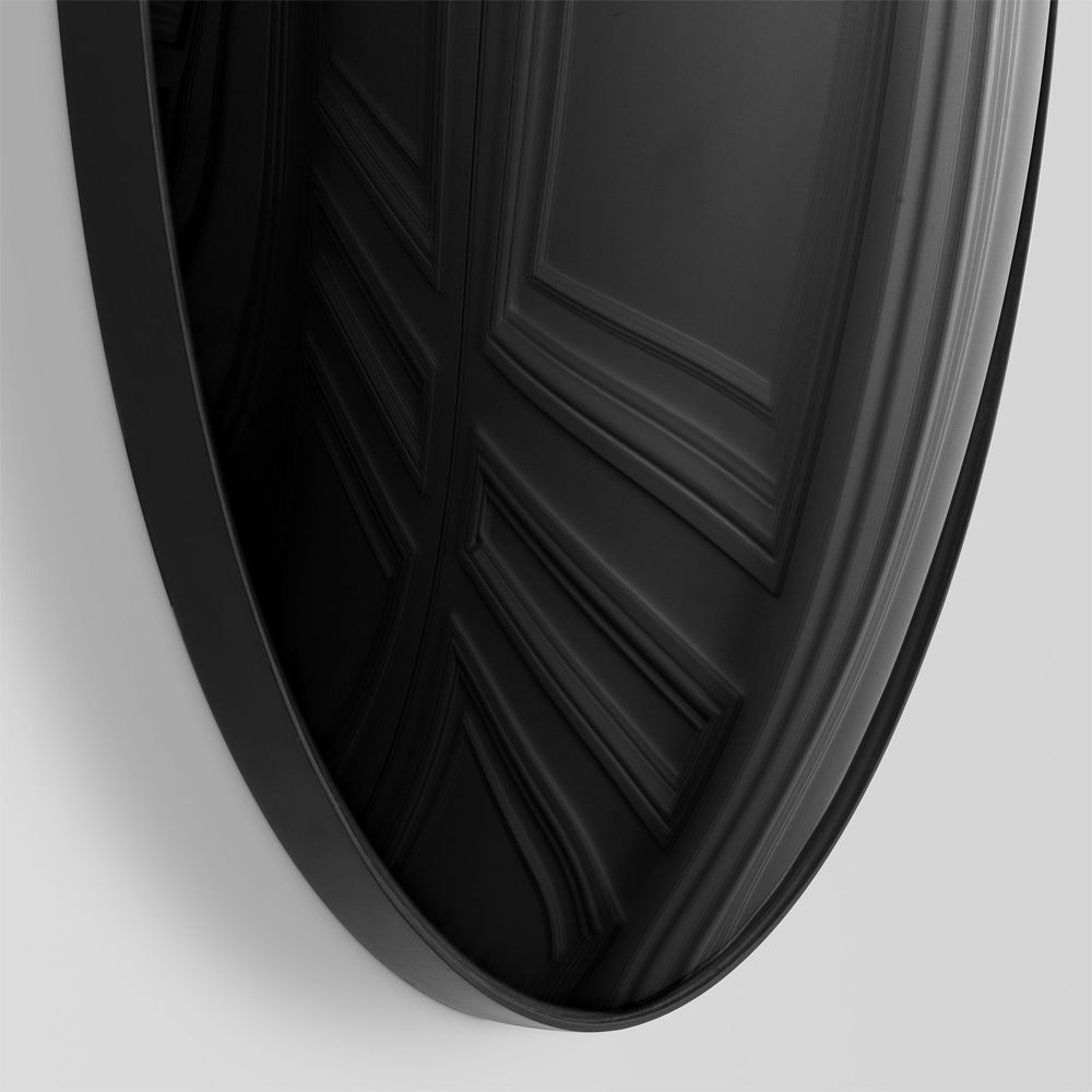 A luxurious round wall mirror with a black convex surface
