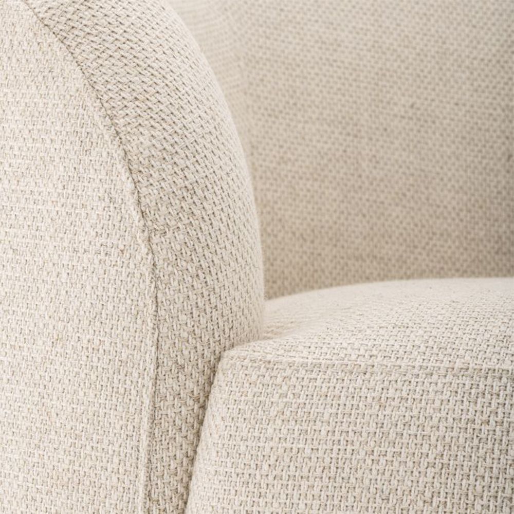 A sophisticated, curvaceous and asymmetric natural linen sofa by Eichholtz 
