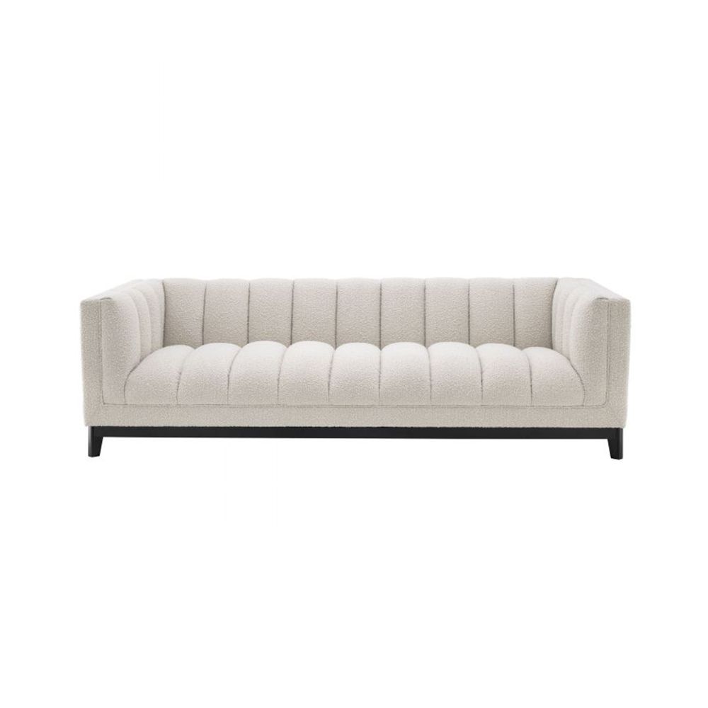 A cosy and luxurious boucle cream sofa with a contrasting black finish base by Eichholtz 