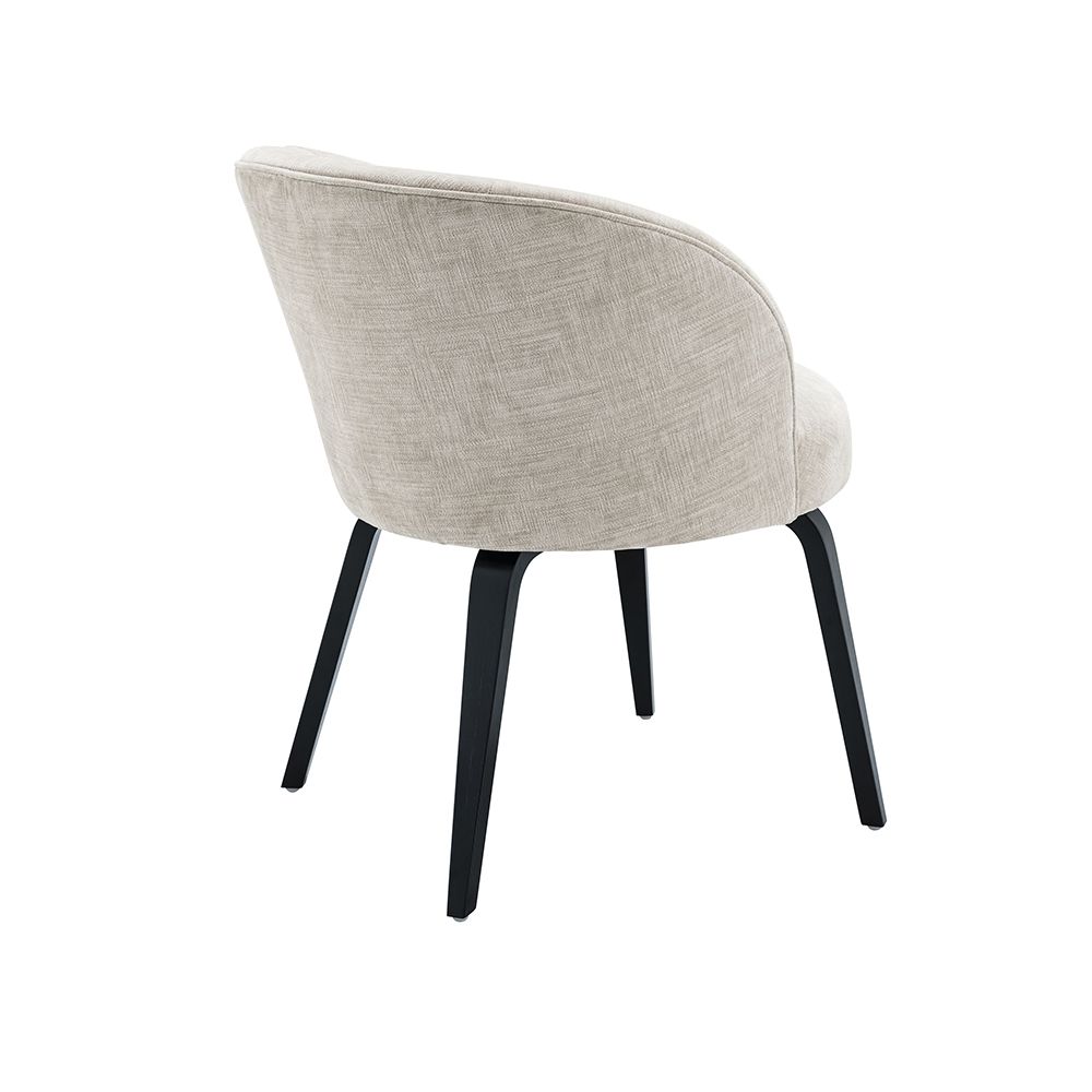 A stylish dining chair by Eichholtz with a beige upholstery, curved back and black tapered legs