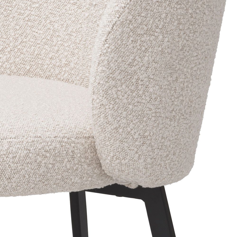 A beautiful set of dining chairs with a stunning boucle cream upholstery and black tapered legs 