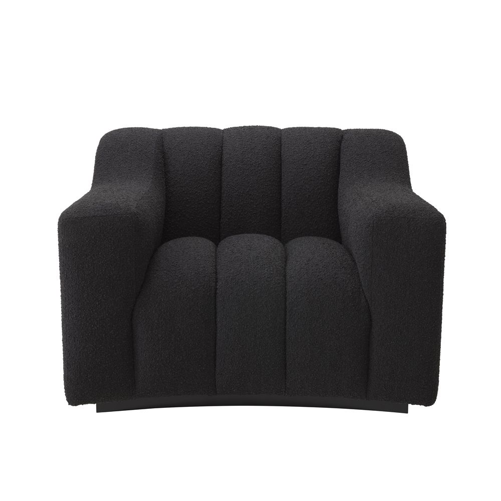 A sumptuous and sophisticated black boucle armchair