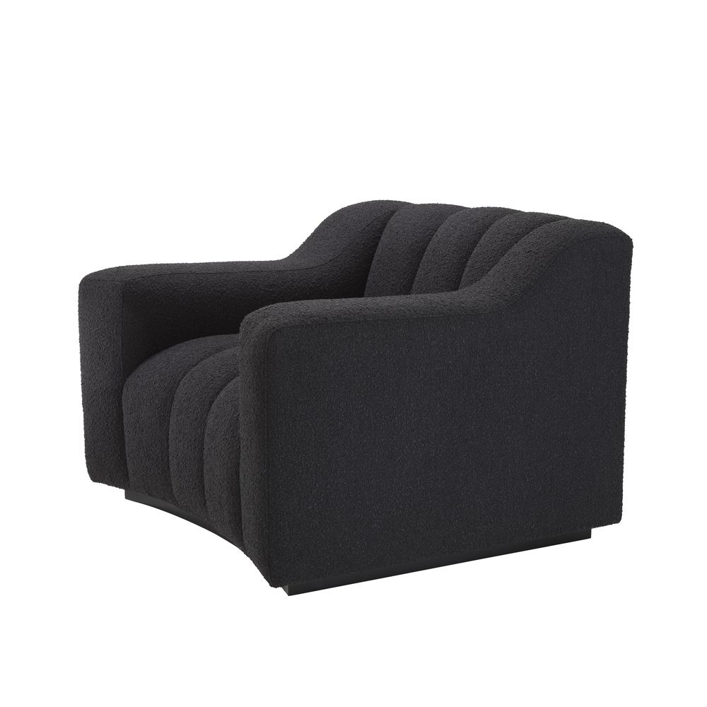 A sumptuous and sophisticated black boucle armchair