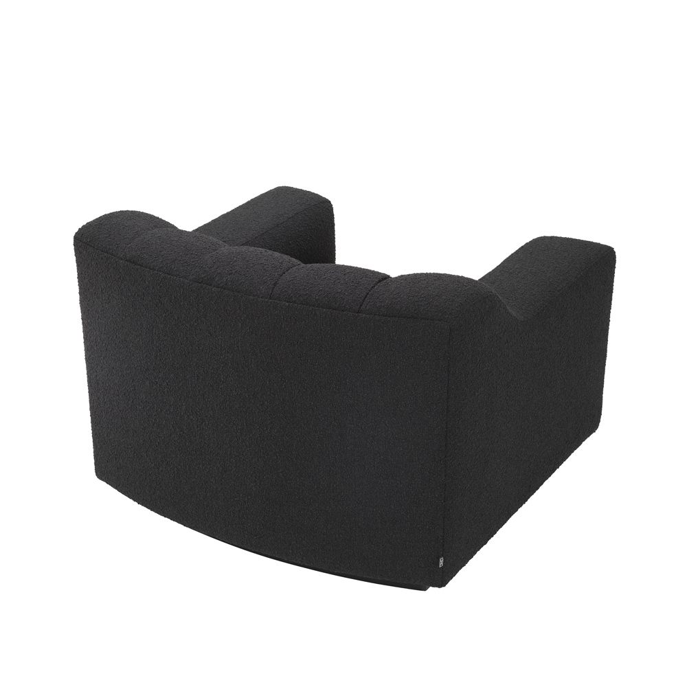 A sumptuous and sophisticated black boucle armchair