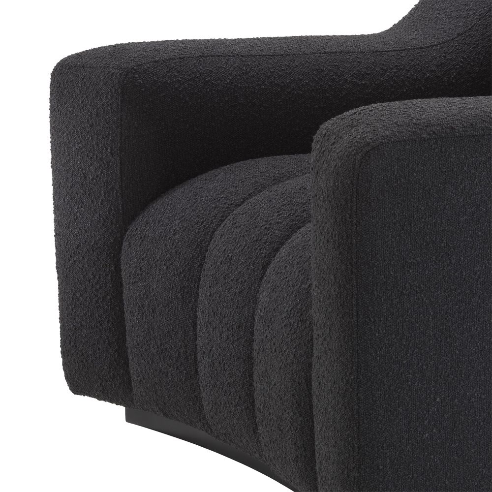 A sumptuous and sophisticated black boucle armchair