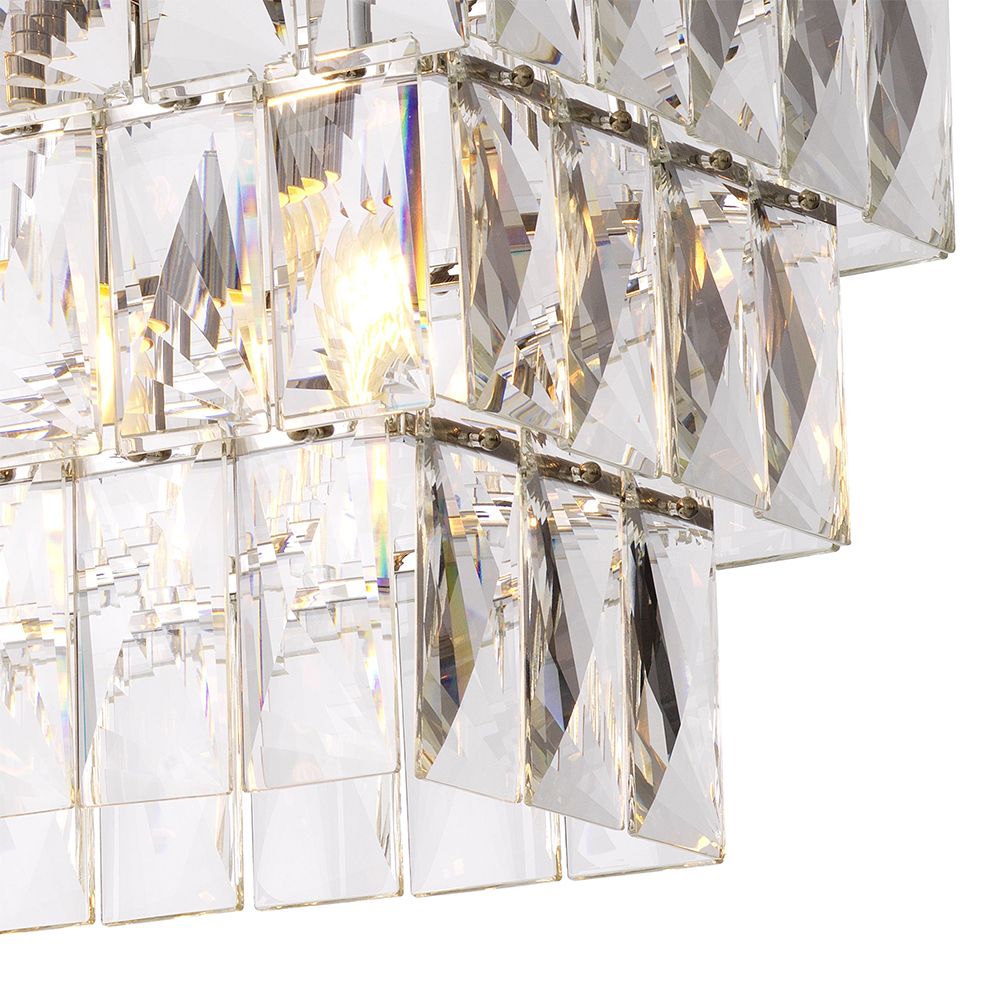 A luxurious rectangular chandelier by Eichholtz with a glamorous crystal glass fitting and nickel finish 