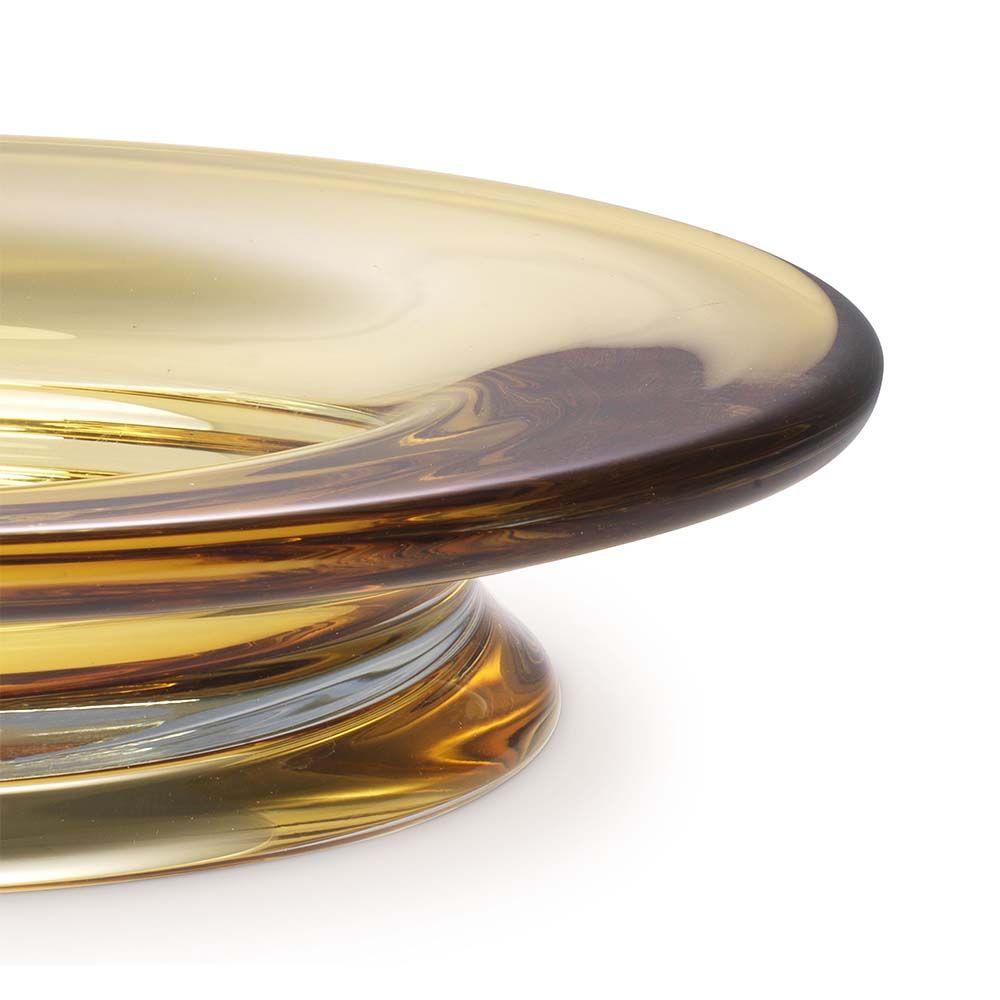 A handcrafted bowl blown from yellow glass.