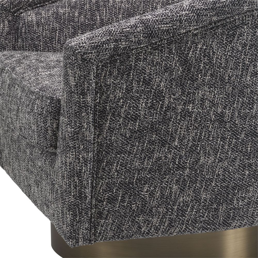 A stylish dark grey armchair with a matte gold swivel base