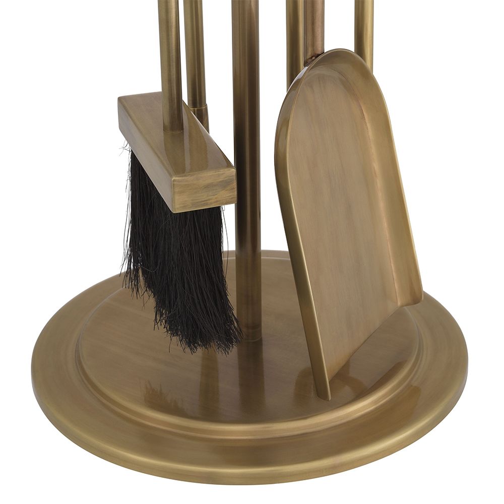 A luxury fire tool set by Eichholtz with a vintage brass finish