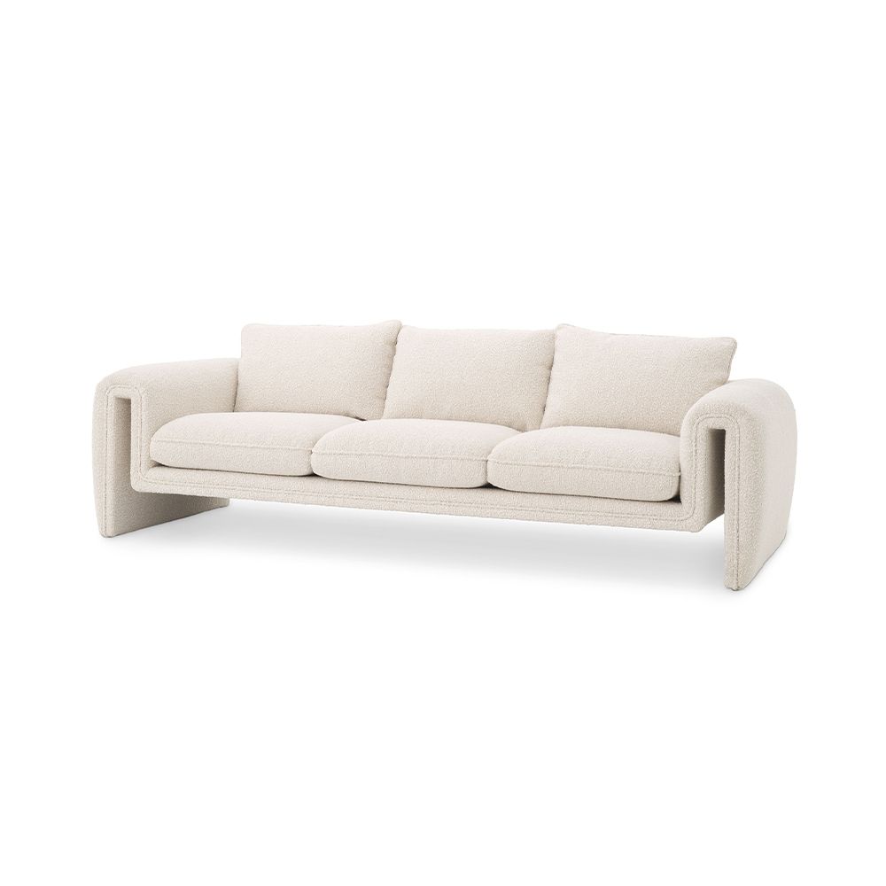 A unique and distinctive sofa by Eichholtz with a bouclé cream upholstery and free flowing shape