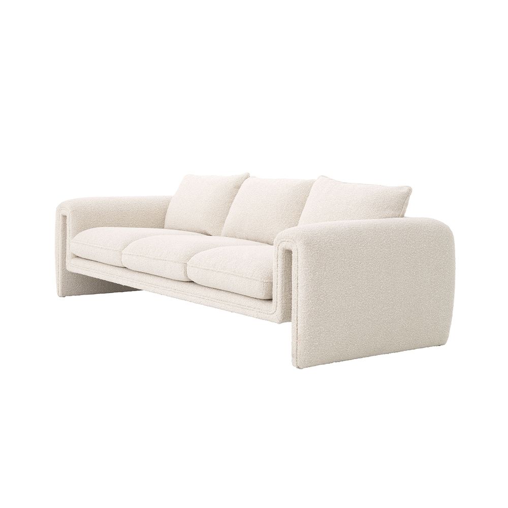 A unique and distinctive sofa by Eichholtz with a bouclé cream upholstery and free flowing shape