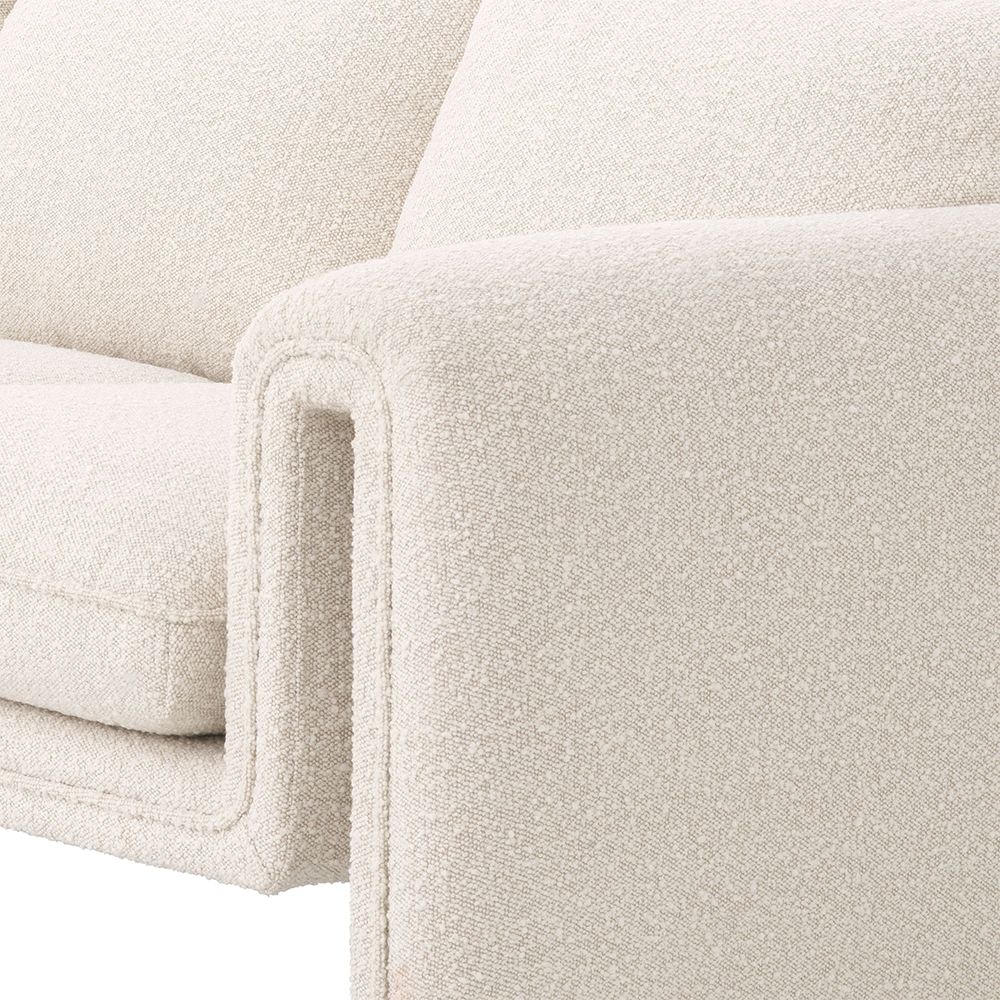 A unique and distinctive sofa by Eichholtz with a bouclé cream upholstery and free flowing shape