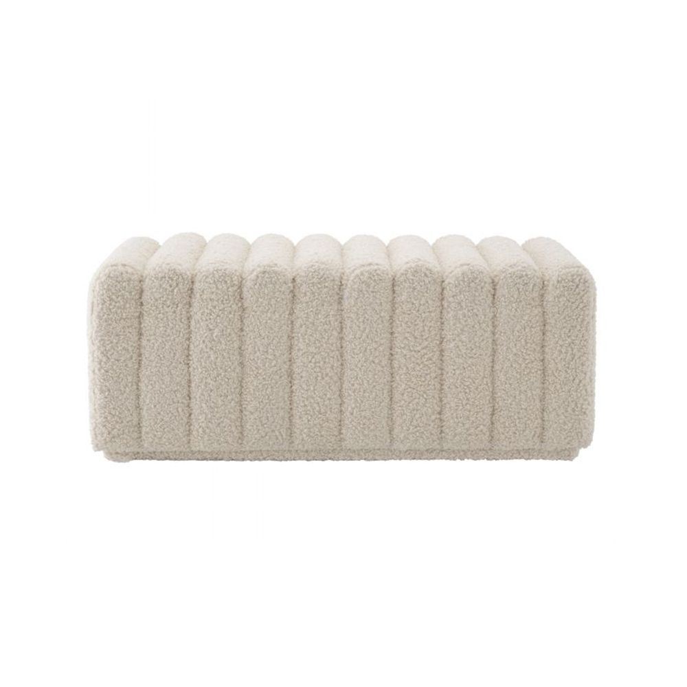 A beautiful bench by Eichholtz upholstered in a faux shearling fabric with deep channel stitching 
