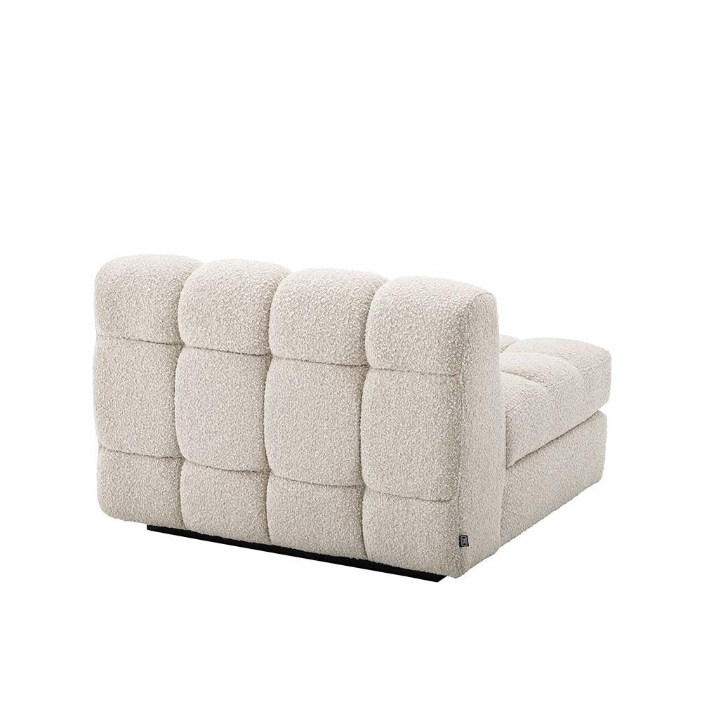 Middle sofa section upholstered in a boucle cream fabric with a black base.
