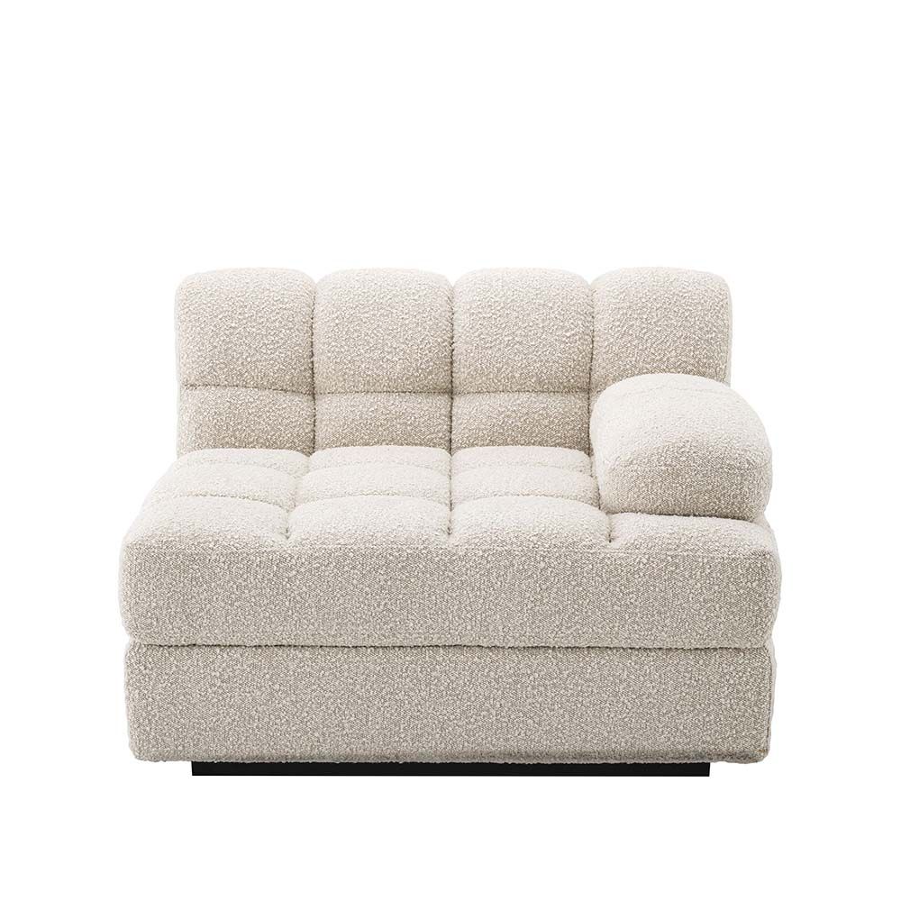 A right facing sofa upholstered in a boucle fabric mounted on a black base.