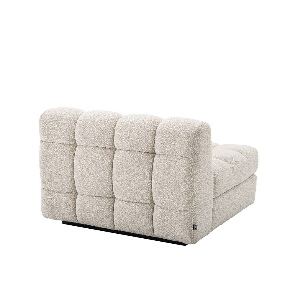 A right facing sofa upholstered in a boucle fabric mounted on a black base.