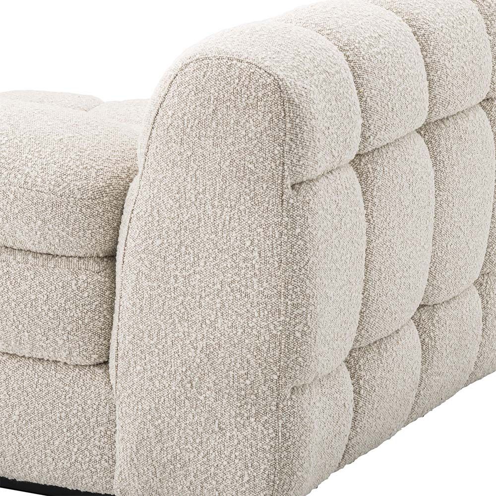 A right facing sofa upholstered in a boucle fabric mounted on a black base.