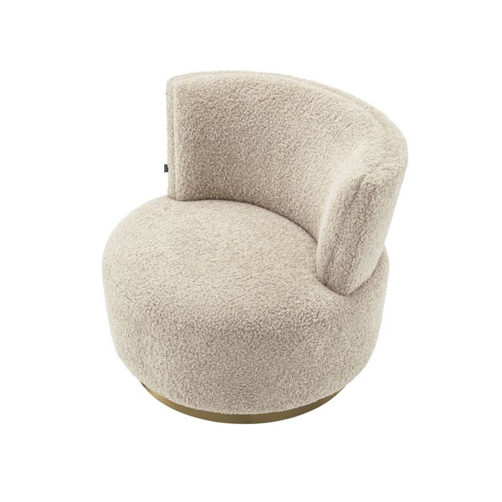 A luxuriously soft curvaceous swivel chair by Eichholtz with a brushed brass swivel base