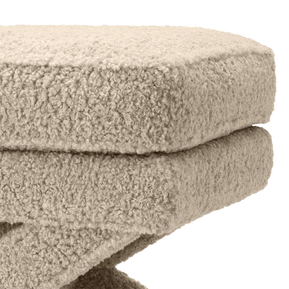 A stunning fluffy brown ottoman with x-shaped legs 