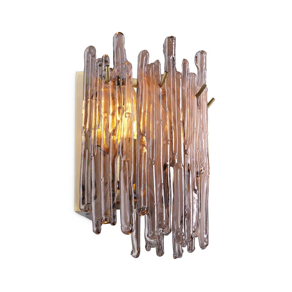 A wall lamp with icicle styled smoked glass and a light brass finish.