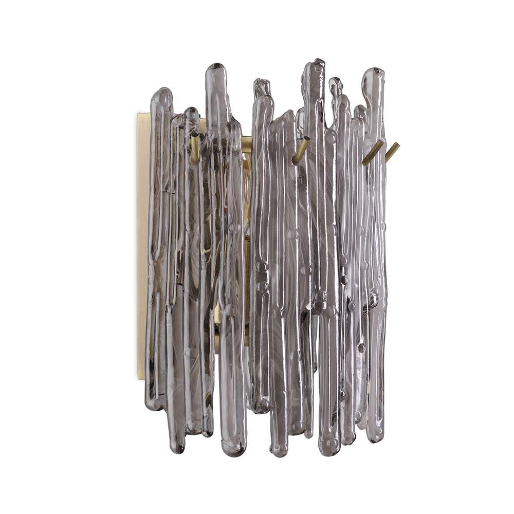 A wall lamp with icicle styled smoked glass and a light brass finish.