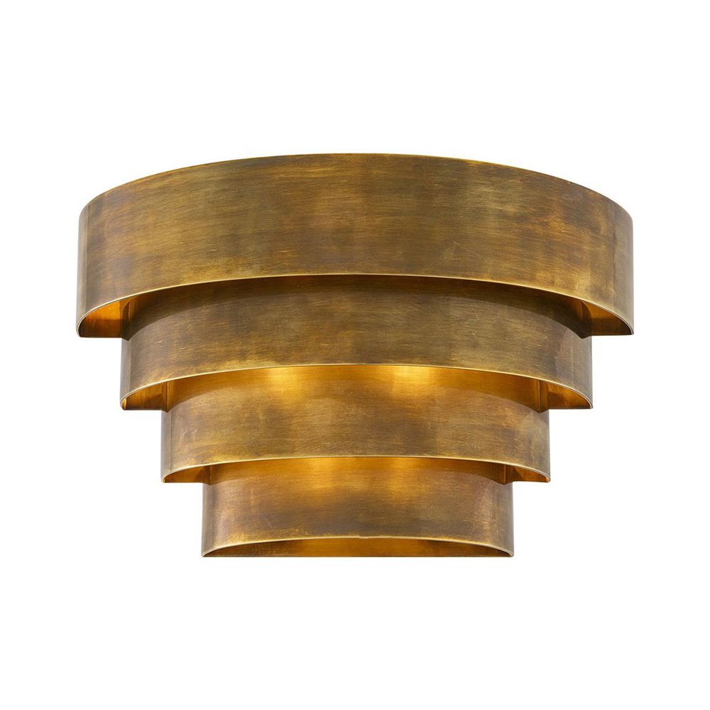 A statement wall lamp by Eichholtz with a vintage brass finish