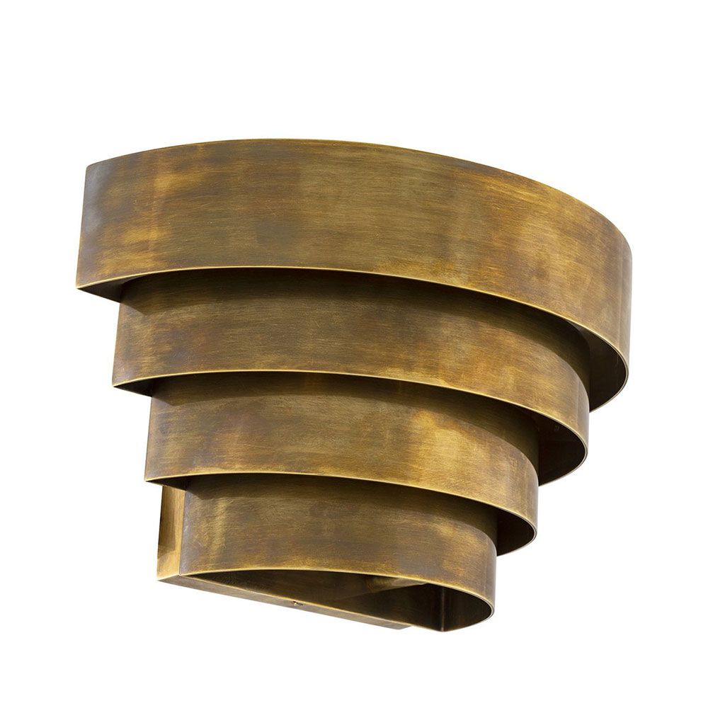 A statement wall lamp by Eichholtz with a vintage brass finish