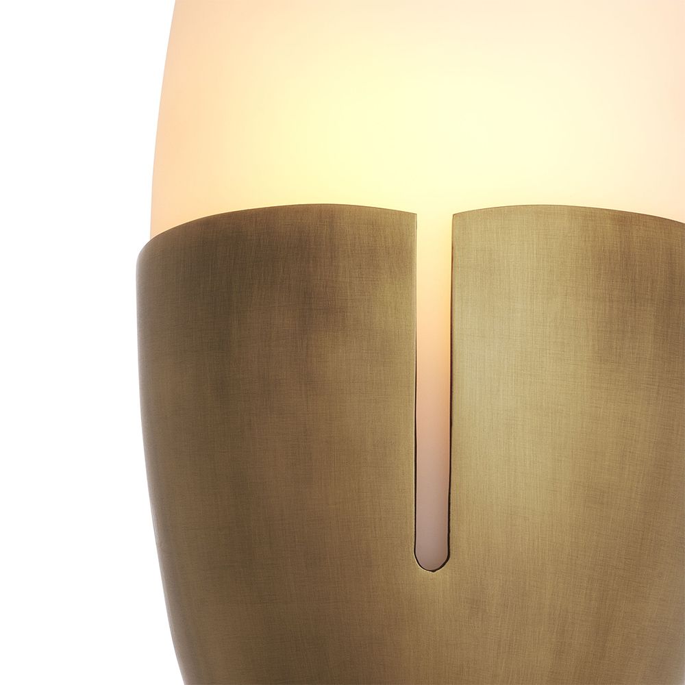 An Art Deco style wall lamp by Eichholtz with an oval shape and antique brass finish 