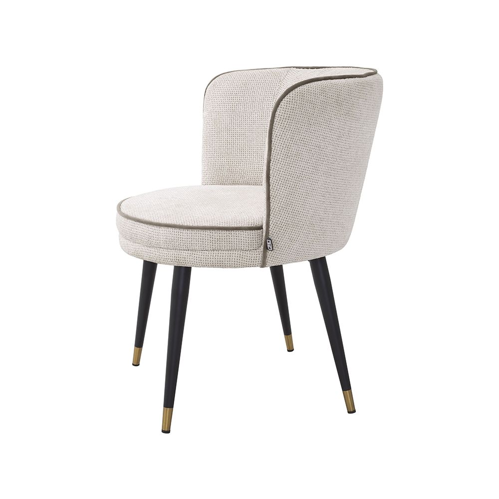 A luxury dining chair by Eichholtz with a retro design featuring a swivel seat and Lyssa Off-White upholstery