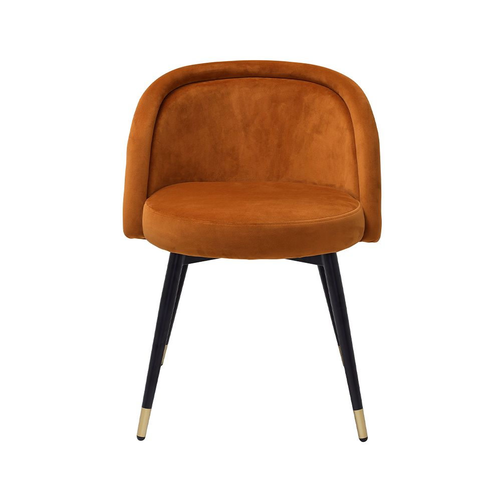 A luxury set of dining chairs with an orange velvet upholstery and golden capped feet