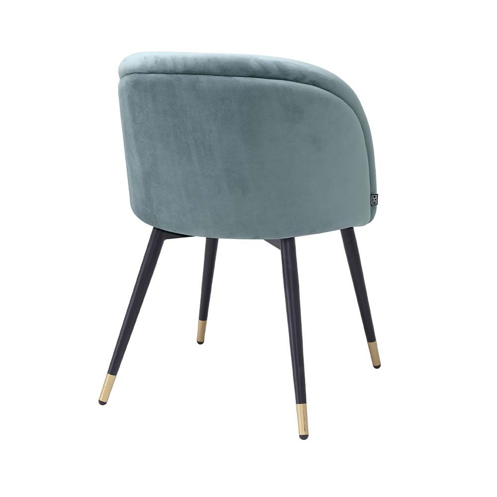 Pair of blue velvet dining chairs with black legs and brass tipped feet.