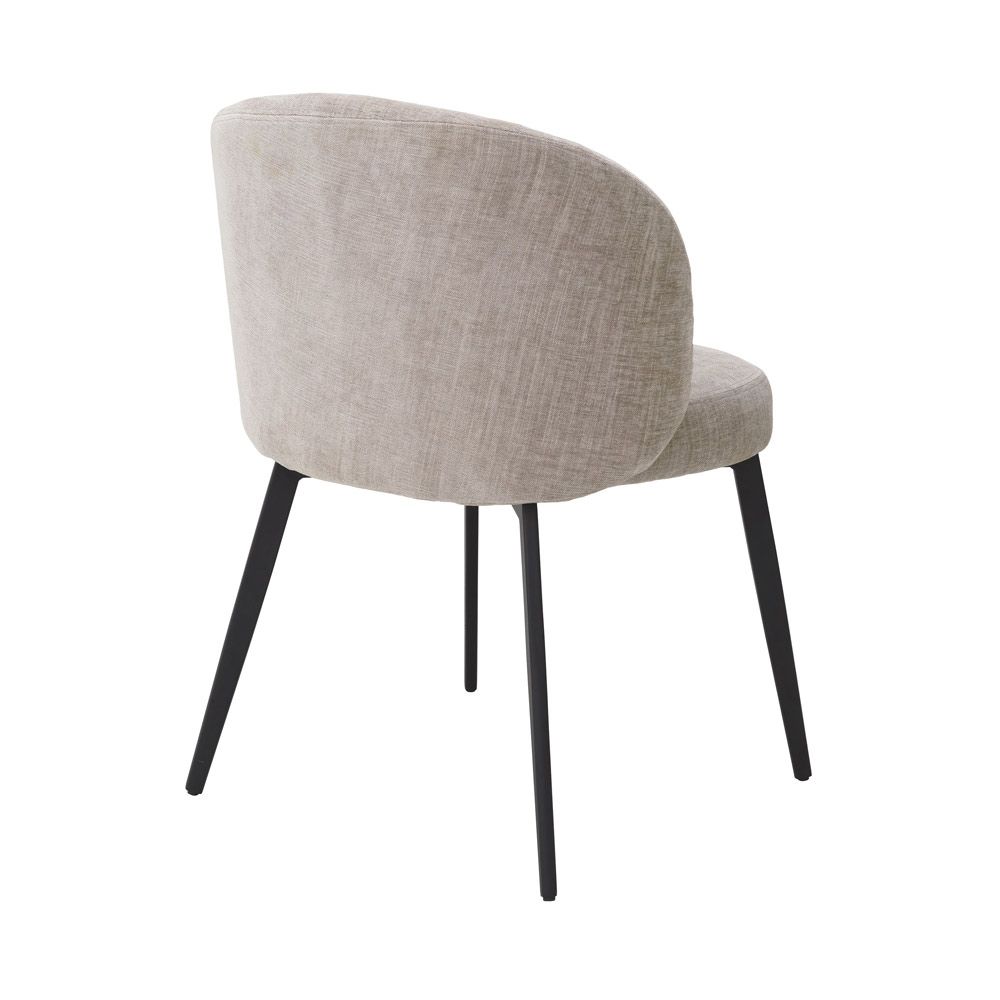 A set of chic dining chairs from Eichholtz with a gorgeous grey upholstery and black tapered legs 