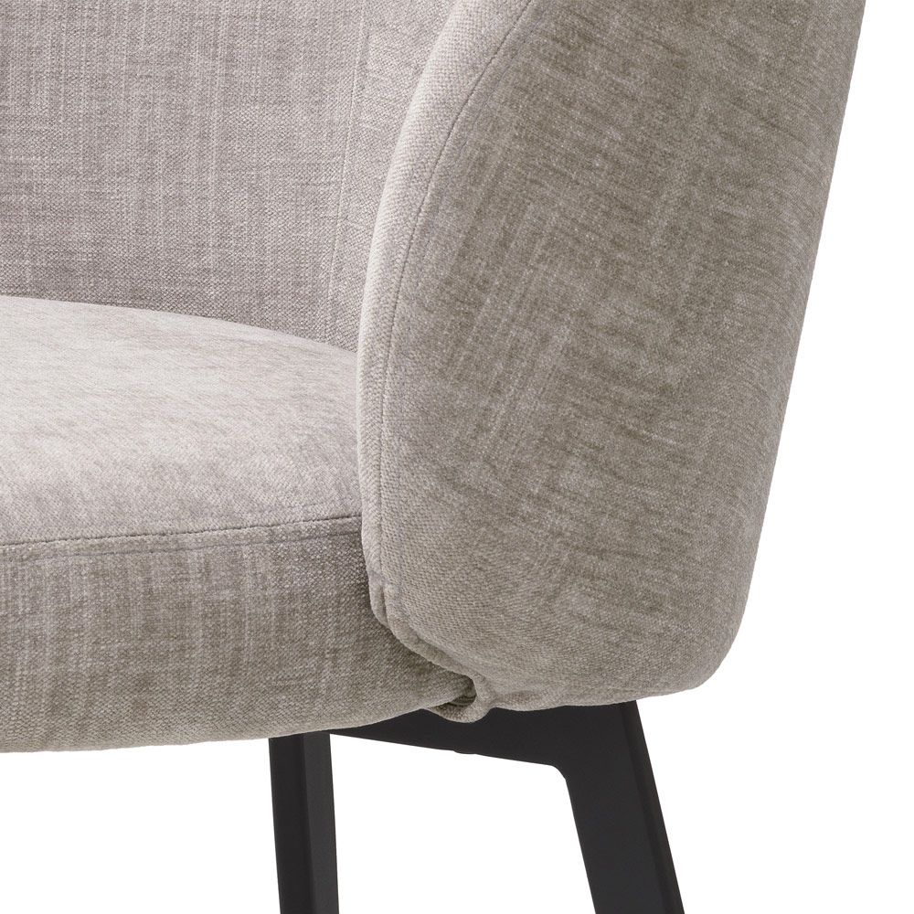 A set of chic dining chairs from Eichholtz with a gorgeous grey upholstery and black tapered legs 