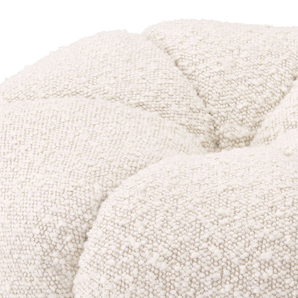 A stunning stool by Eichholtz with a boucle cream upholstery, deep channel stitching and a brushed brass base
