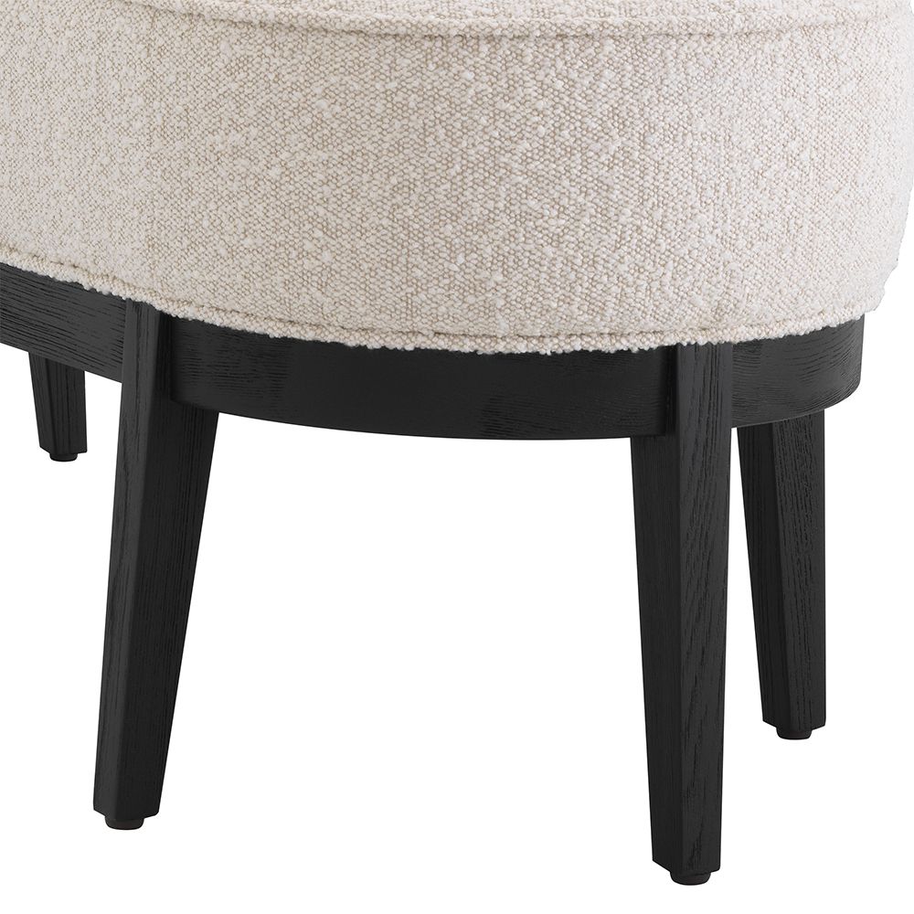 An elegant bench by Eichholtz with a luxury bouclé cream upholstery and beautiful black finished frame