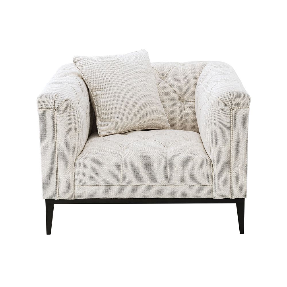 A luxurious armchair by Eichholtz with a square shaped design featuring a Lyssa off-white upholstery, deep buttoned stitching and a black gunmetal base