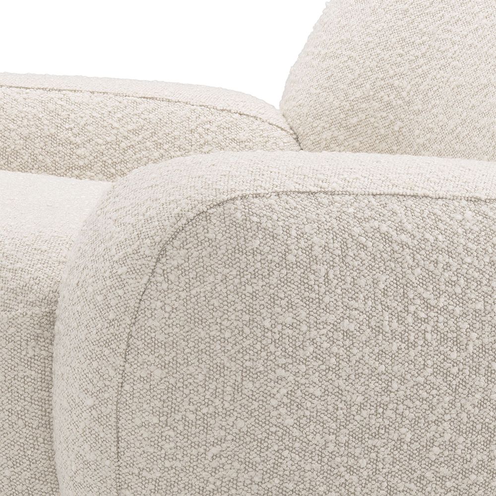 A curvy swivel chair by Eichholtz with a bouclé cream upholstery and brushed brass base 