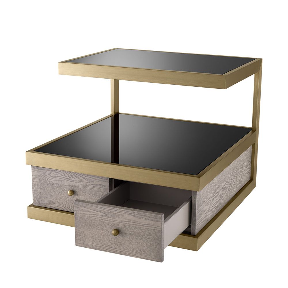 A sophisticated side table by Eichholtz which doubles up as a stylish storage solution with a brass frame and black glass finish