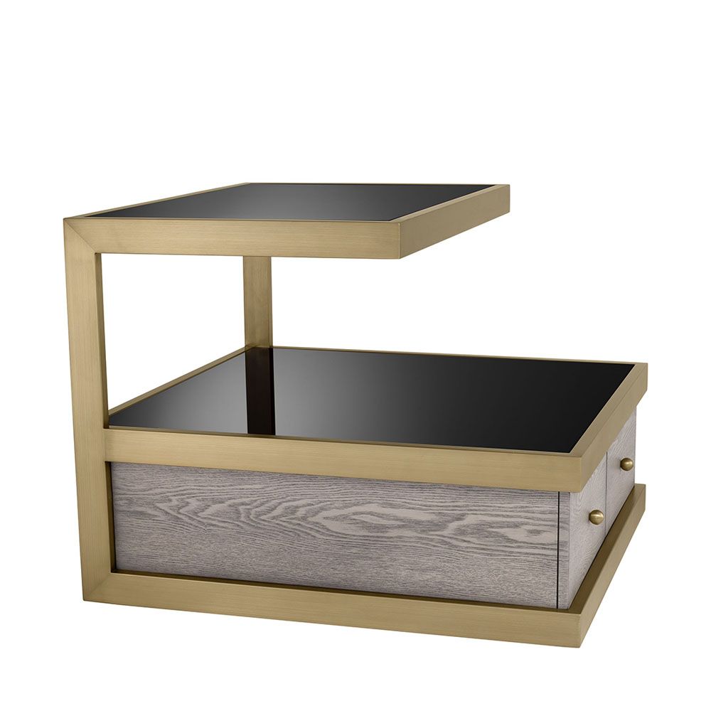 A sophisticated side table by Eichholtz which doubles up as a stylish storage solution with a brass frame and black glass finish