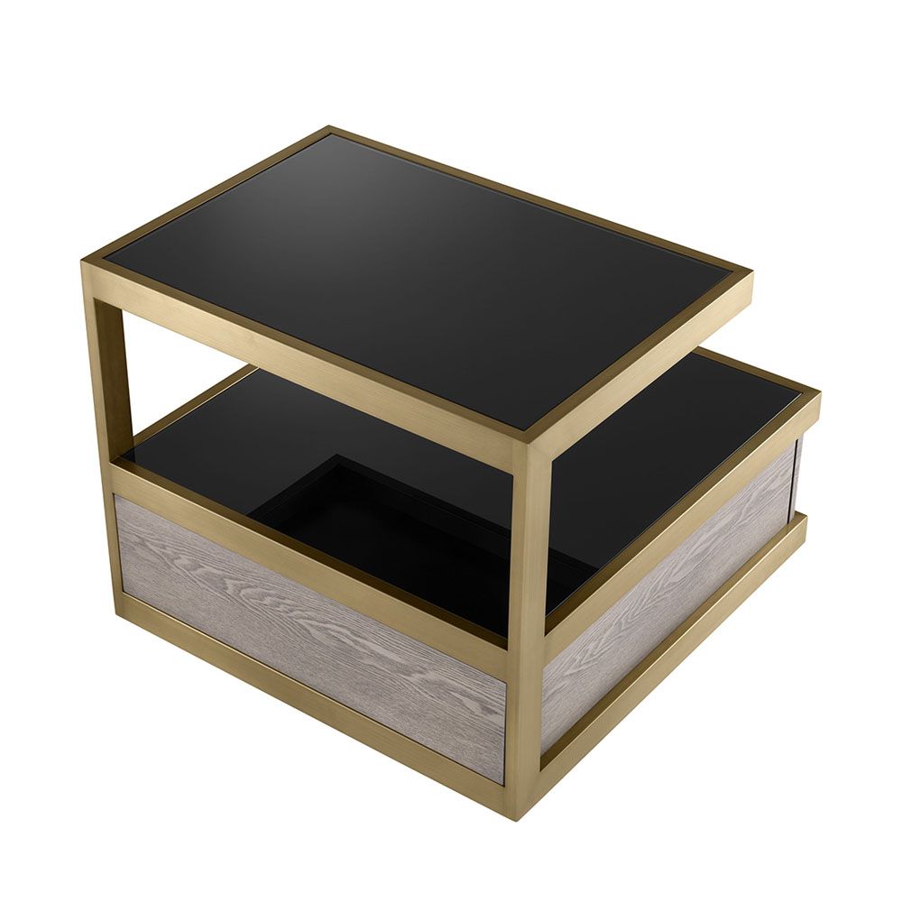 A sophisticated side table by Eichholtz which doubles up as a stylish storage solution with a brass frame and black glass finish