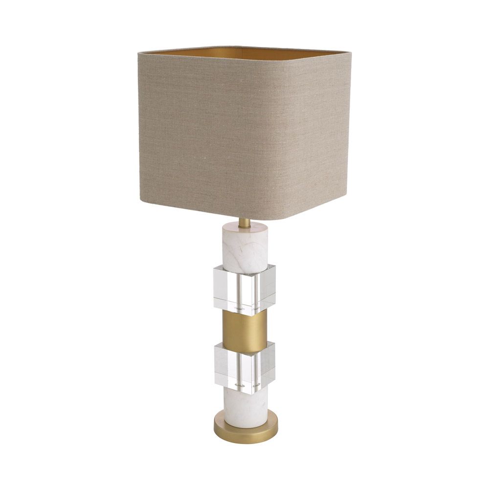 A stylish table lamp by Eichholtz featuring a luxury linen mix shade and marble, crystal glass base with an antique brass finish 