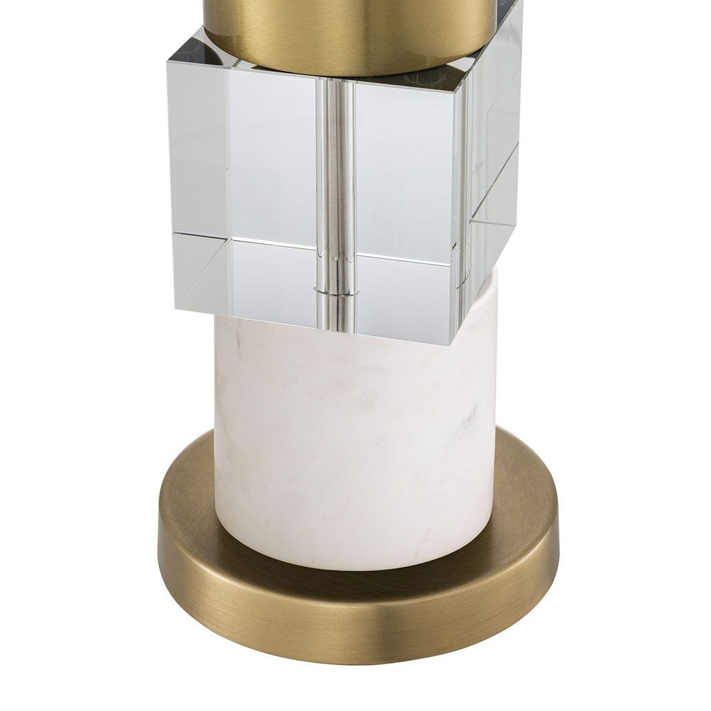 A stylish table lamp by Eichholtz featuring a luxury linen mix shade and marble, crystal glass base with an antique brass finish 
